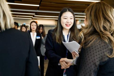 students shaking hands at a career fair