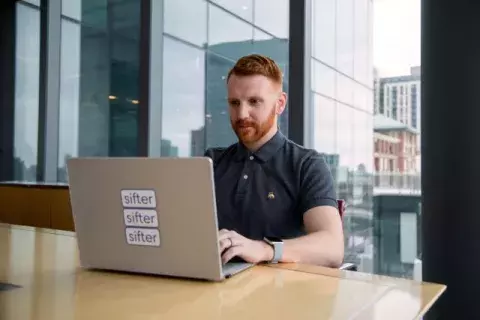 Andrew Lyle at table with laptop