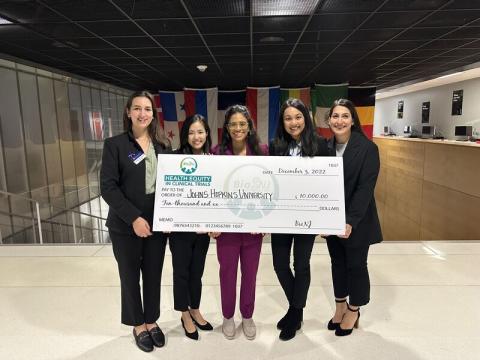 case competition winners holding a check