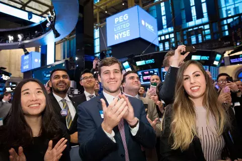 a group of students applauding at the NYSE opening bell