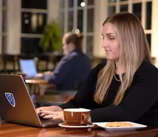 woman a table with laptop