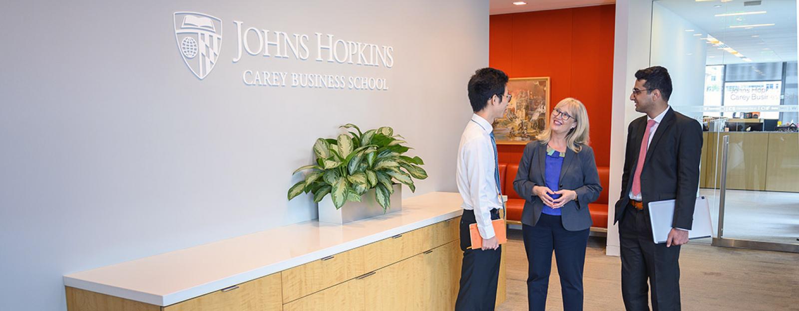 students talking with a career development coach at johns hopkins carey business school