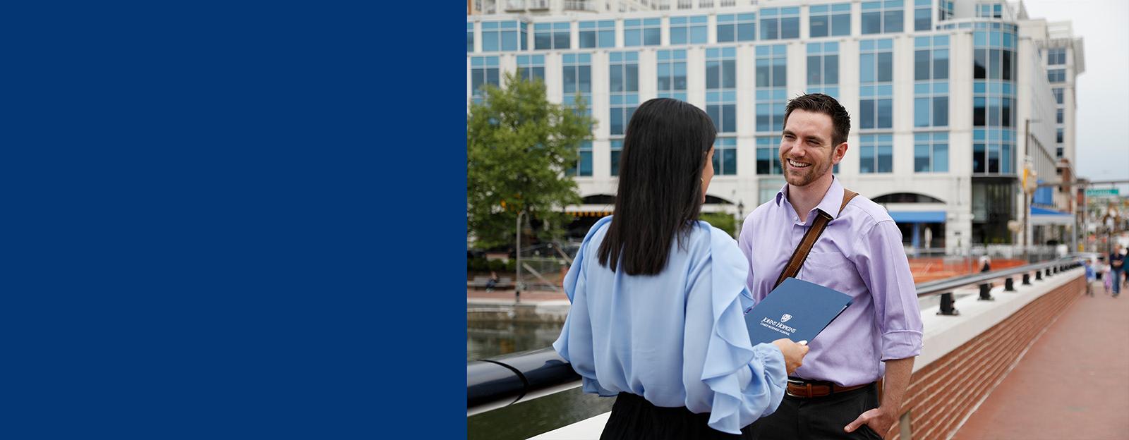 two student outside discussing carey programs