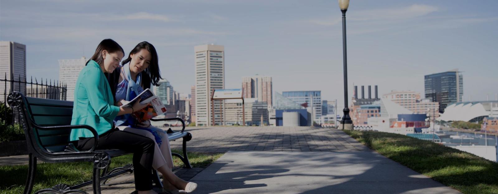 Students siting on a bench outside